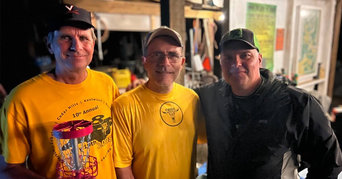 Three men pose for a photo