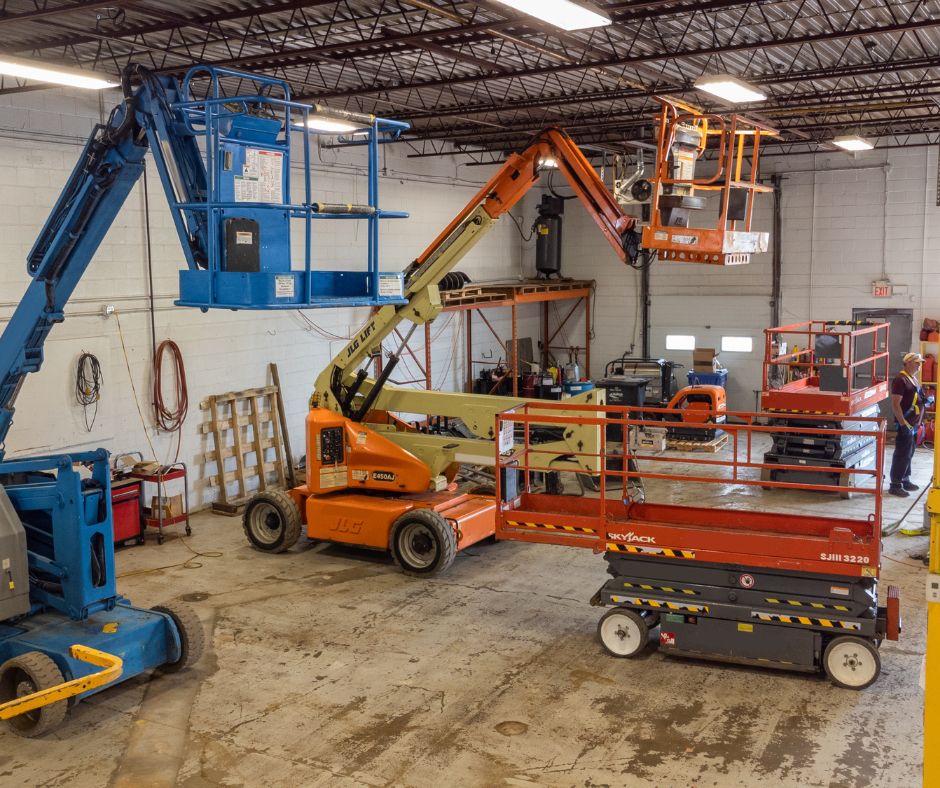 Articulating boom lifts and scissor lifts in a storage facility