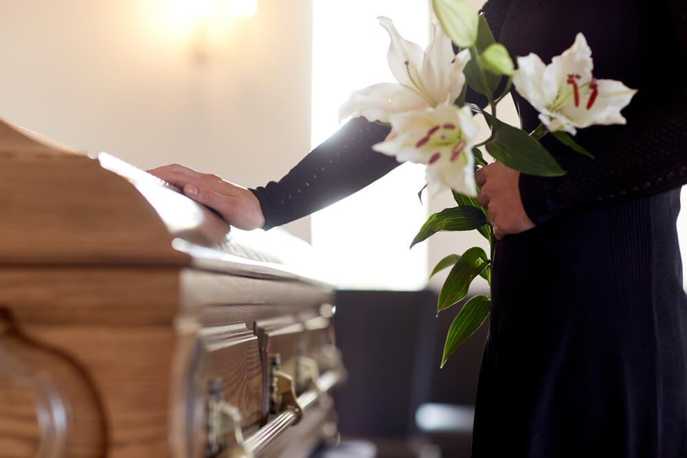 person paying their respects at a funeral