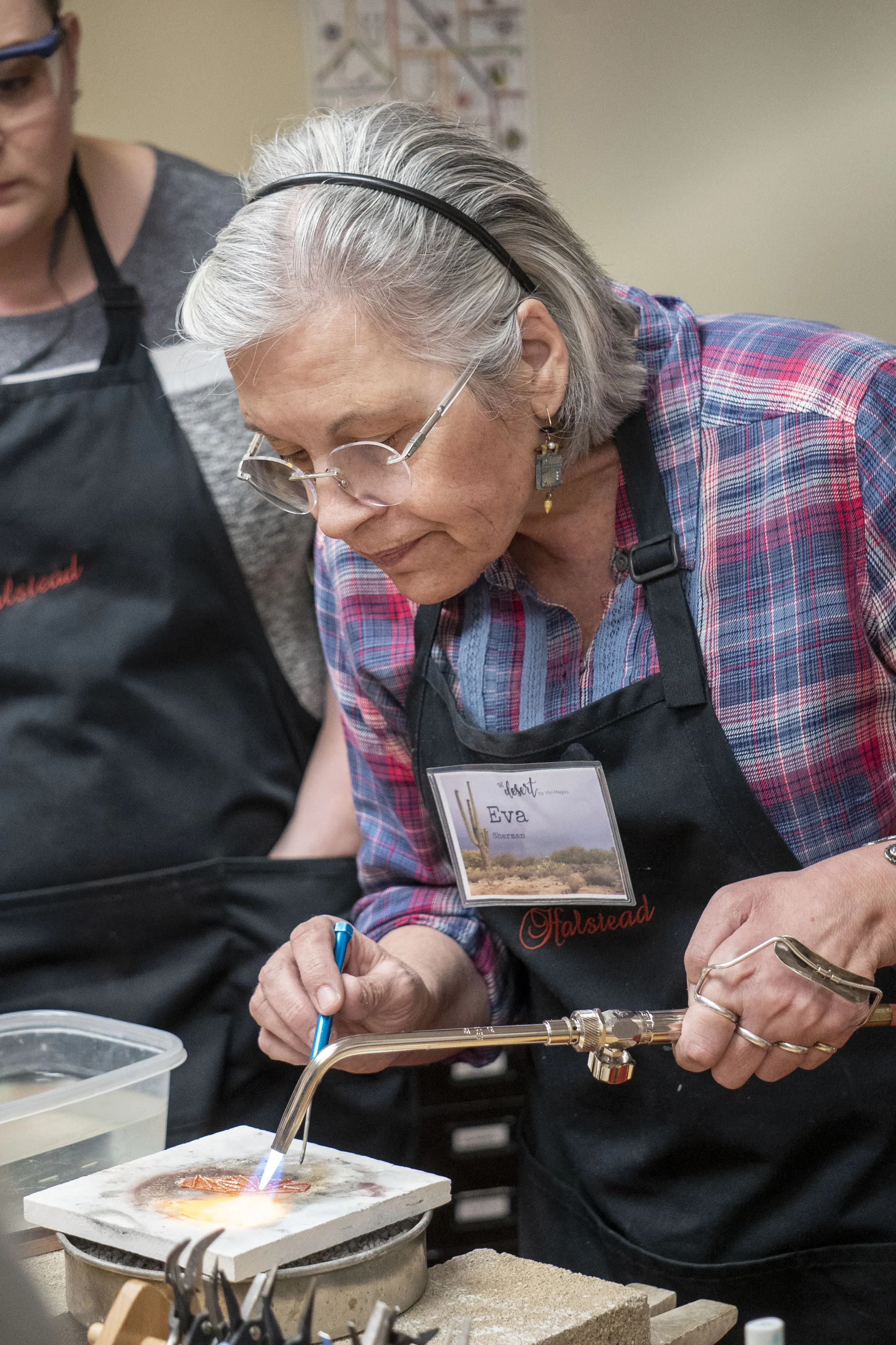 Artist Eva Sherman soldering for making jewelry