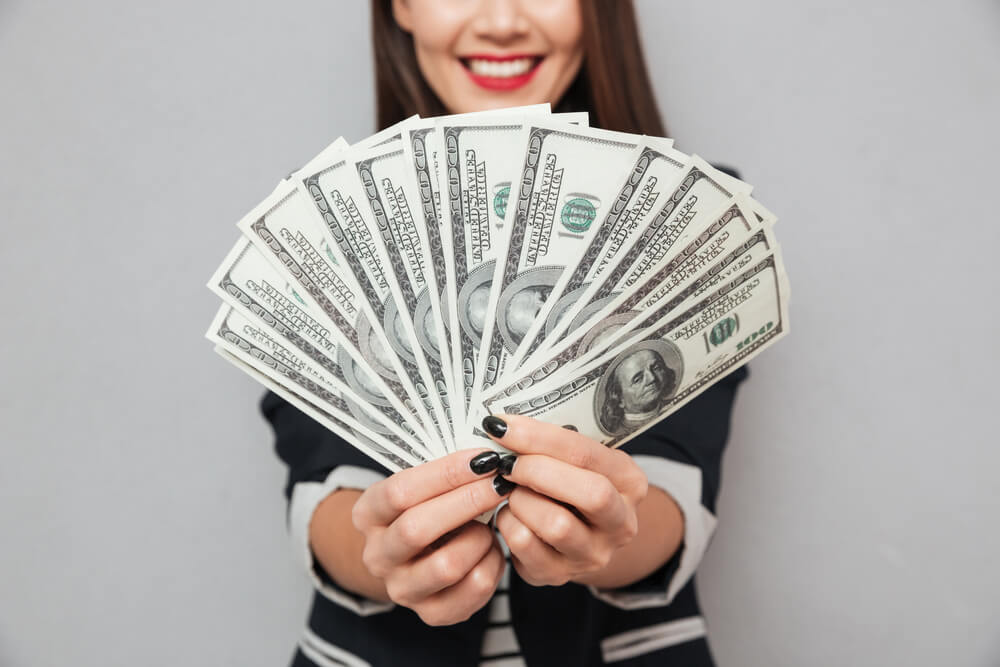 Woman holding auto pawn loan money