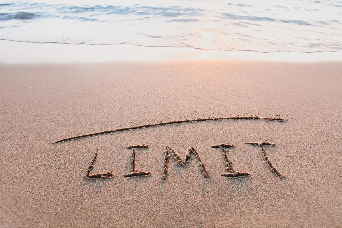 medicares limiting charge written in sand on the beach