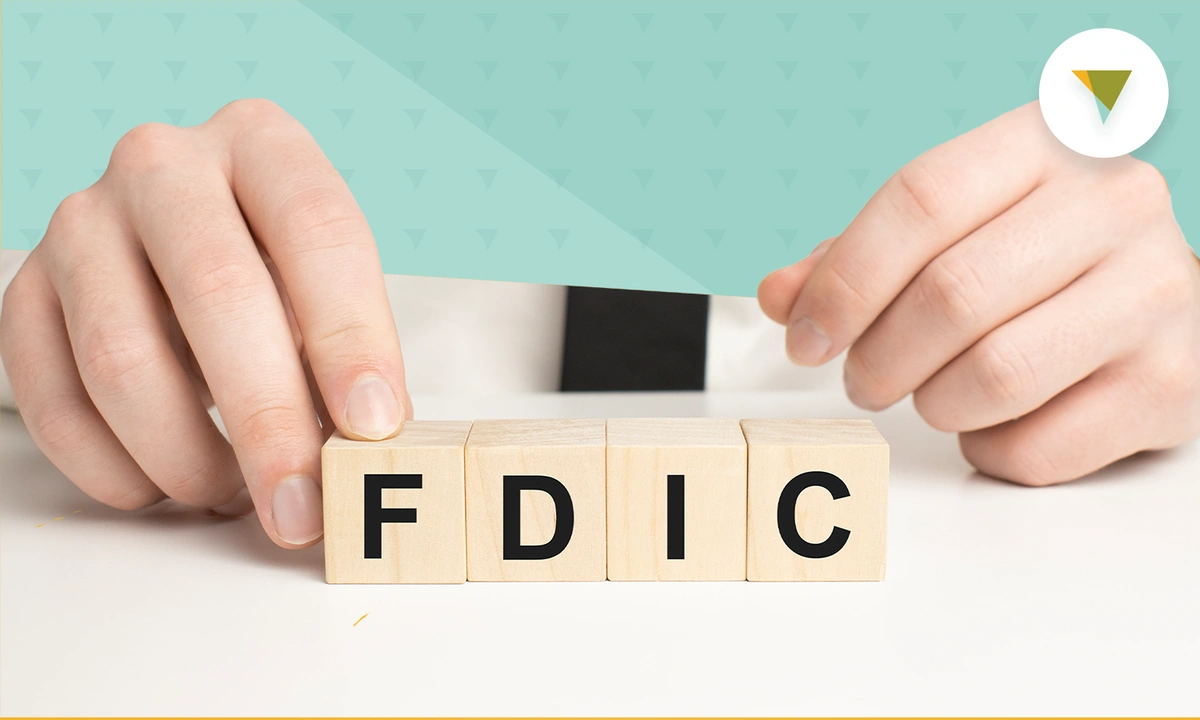 Hands holding blocks spelling out FDIC