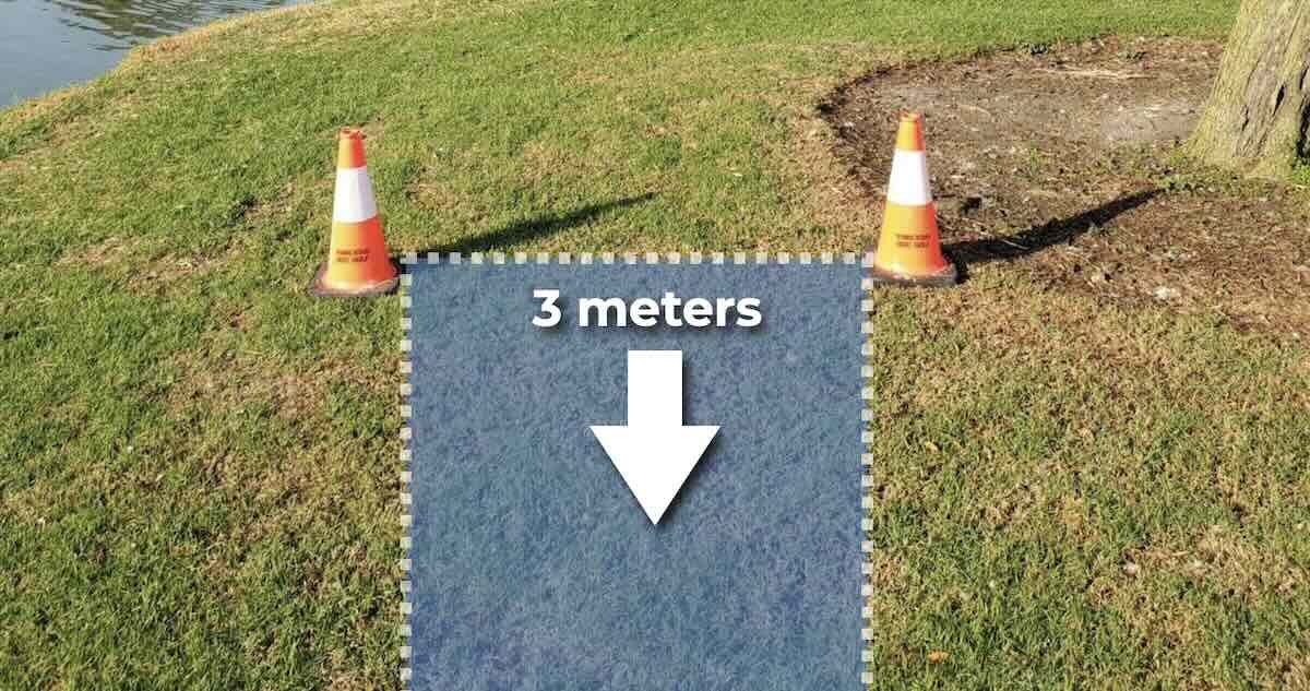 Two traffic cones on grass with an image added to show how they make a disc golf tee pad