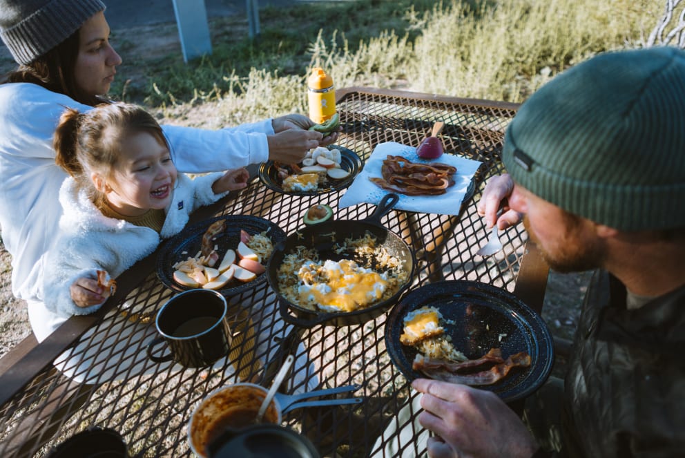 family eating breakfast at the campground