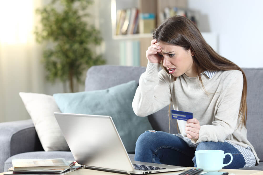 woman tracking her spending to save money on a tight budget
