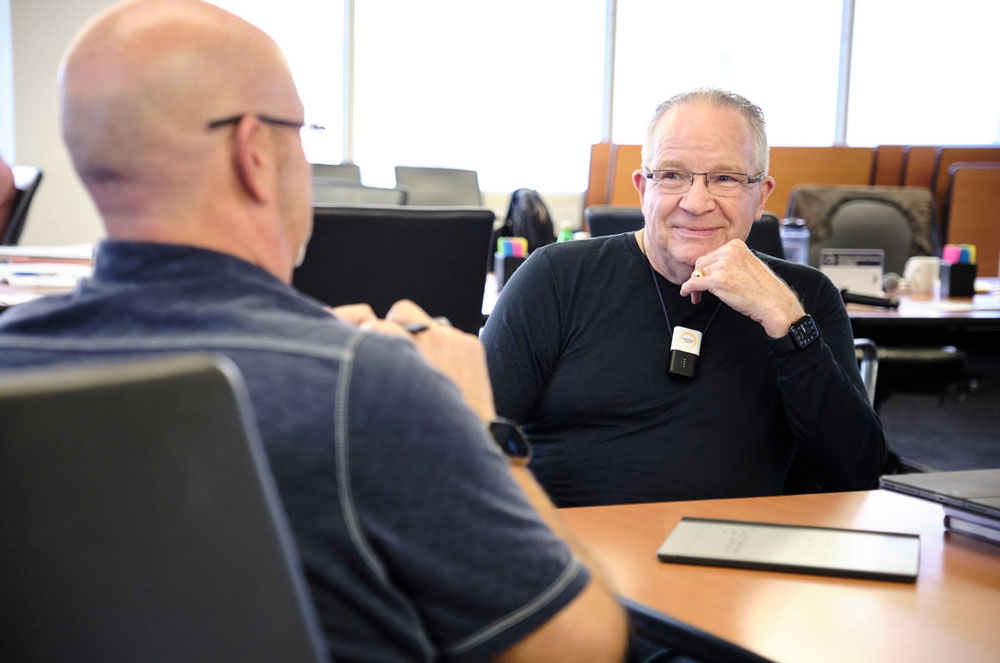 Co-Founder of Strategic Coach, Dan Sullivan, sitting in a workshop with enterpreneural program members 