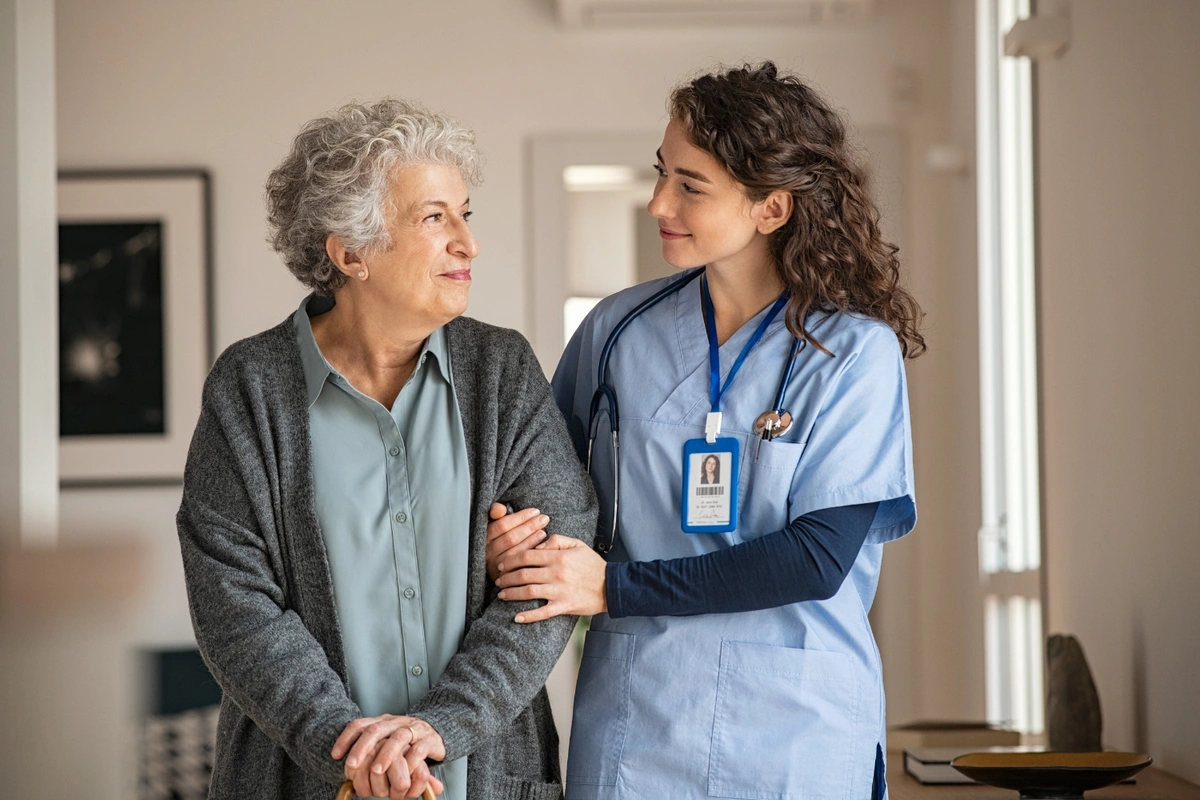 nurse helping patient in long term care