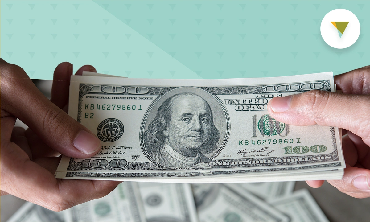 one person handing another a stack of hundred dollar bills