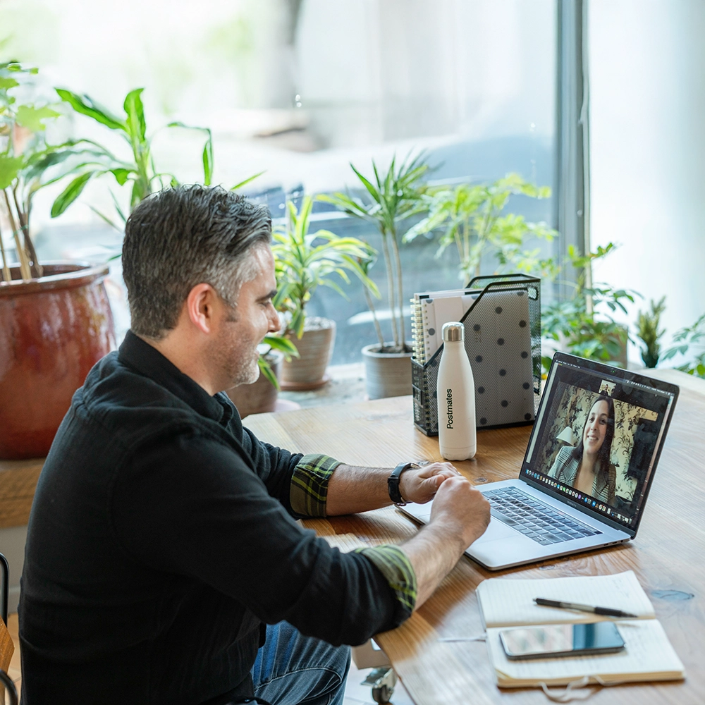A salesperson working in an office on a virtual call.webp