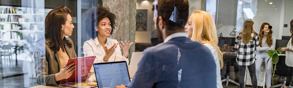 A team working around a table in a modern office