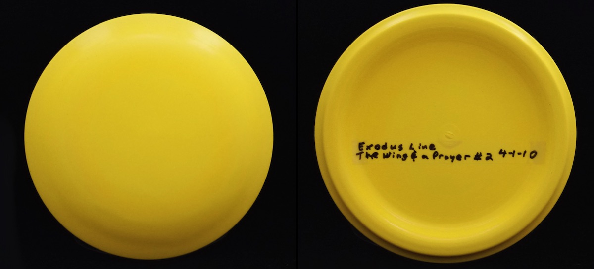 A yellow disc golf disc seen from top and bottom