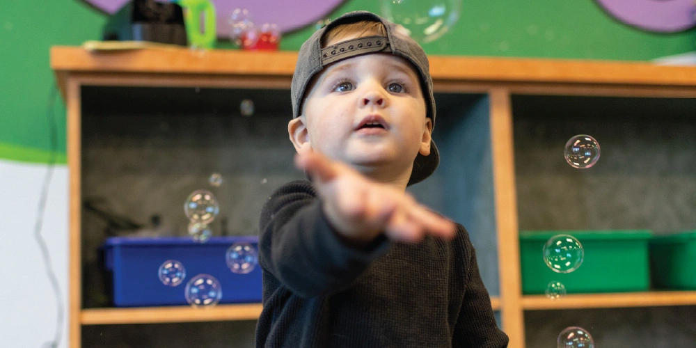 Child playing with bubbles
