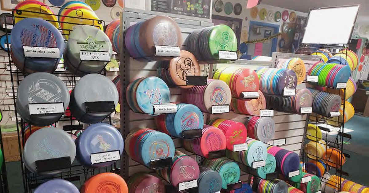 Racks of disc golf discs in a store