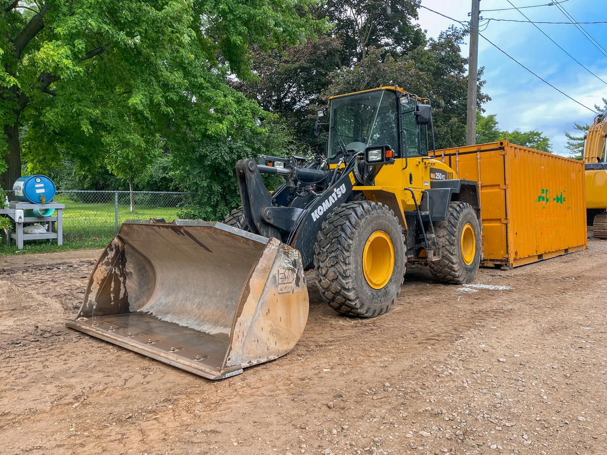 Komatsu wheel loader sitting idle on a project with a bucket attachment