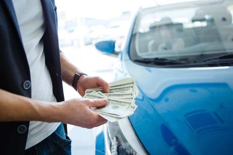 Man holding speedy cash from Nevada Title & Payday Loans, Inc.
