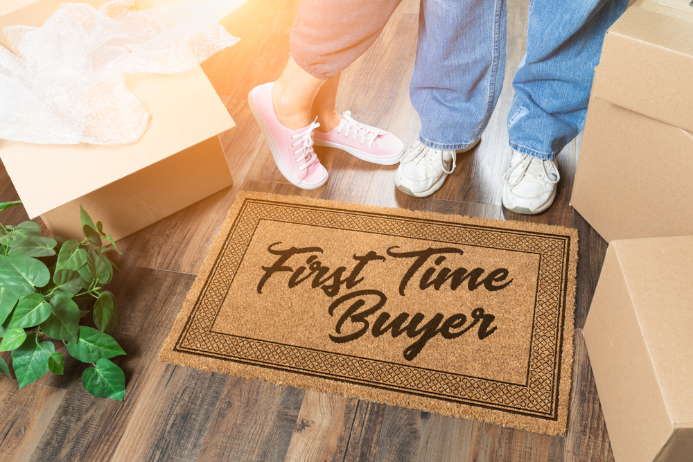 couple standing on first time buyer doormat