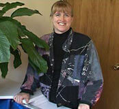 Linda alongside the Endless Pool she used for aquatic therapy during and after pregnancy