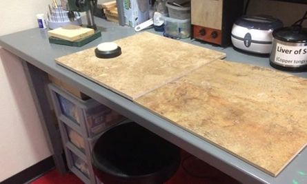 image of a work table with tiles and jewelry making tools on top