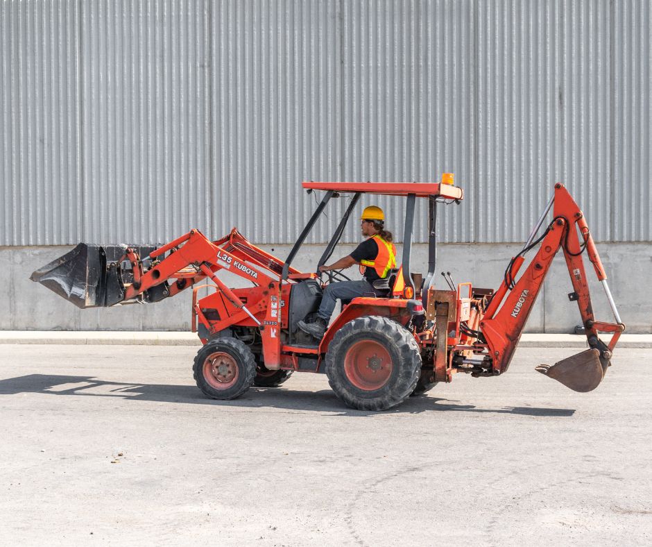 Kubota L35 Tractor Loader with an equipment operator driving around on a project