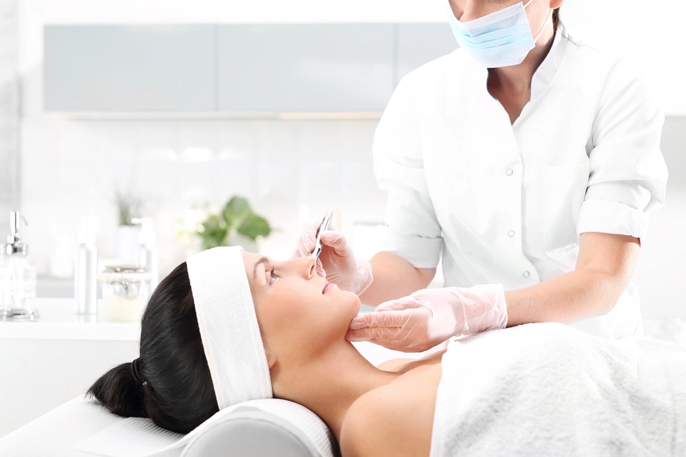 Dermatologist or esthetician working on woman's face