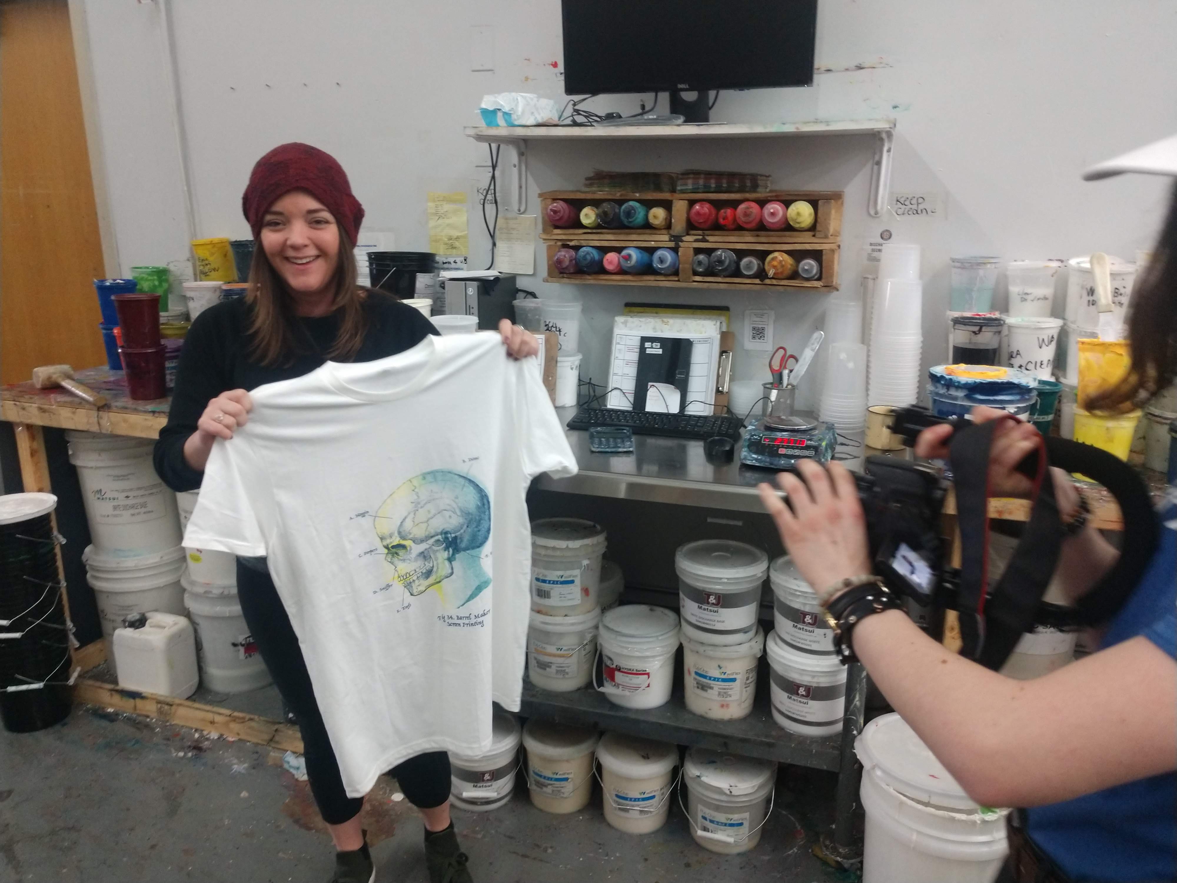 Laura Ezell, customer success at Printavo, showing off her first screen printed shirt