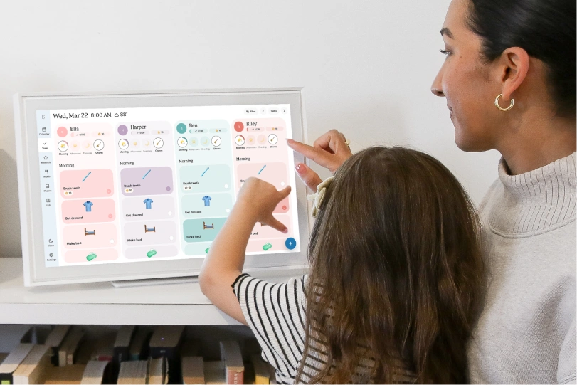 Mother and daughter scheduling chores on Skylight digital calendar