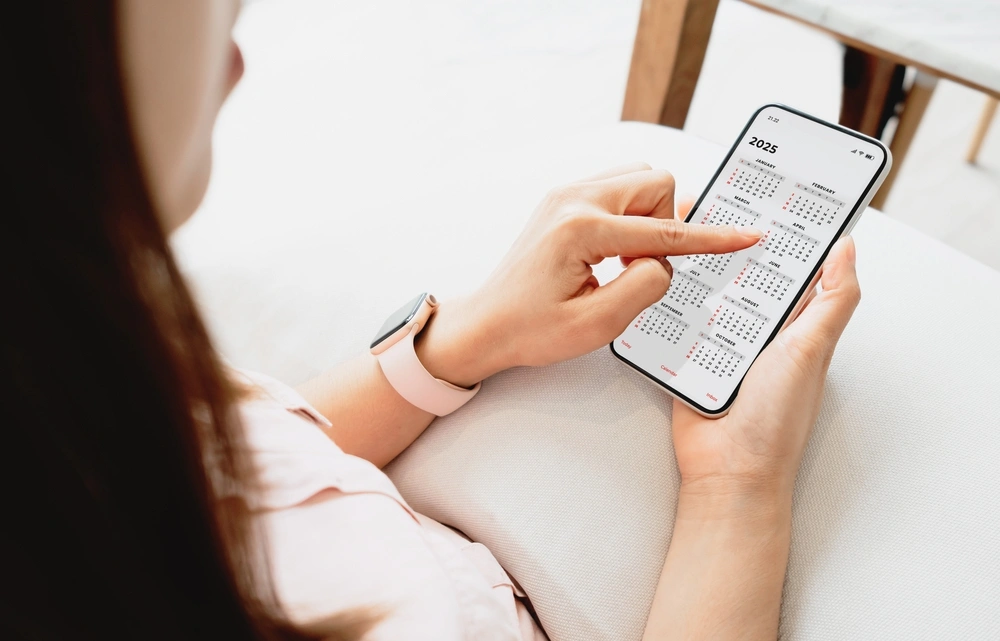 woman looking at the calendar on her phone