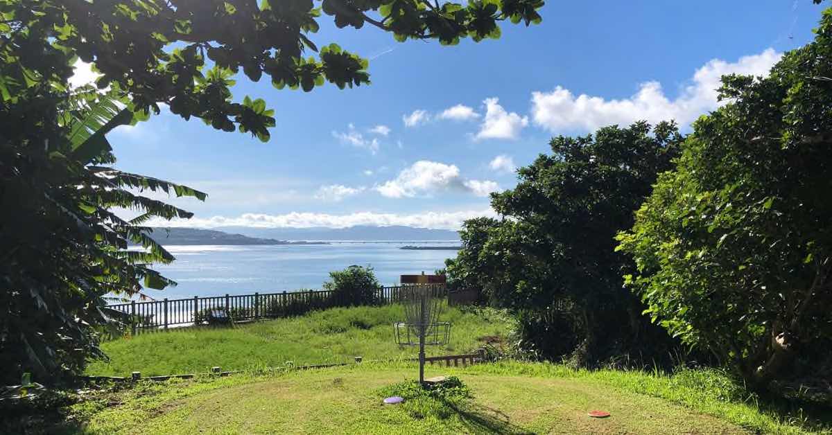 disc golf basket with a view of the ocean behind