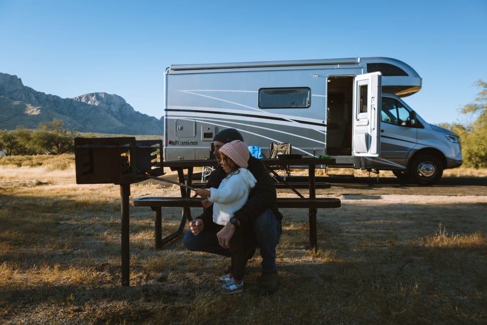 dad and daughter camping in winnebago navion in arizona