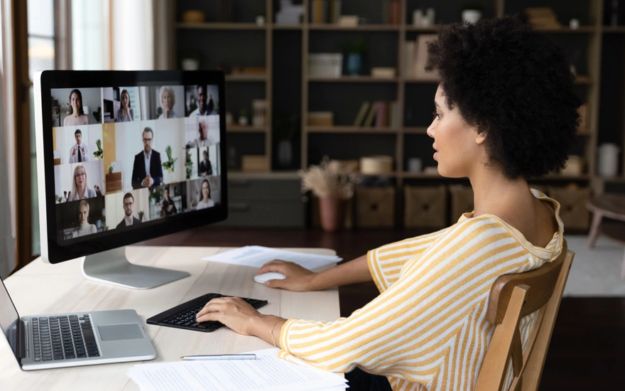 African American business woman holding video conference call conversation on computer with diverse colleagues