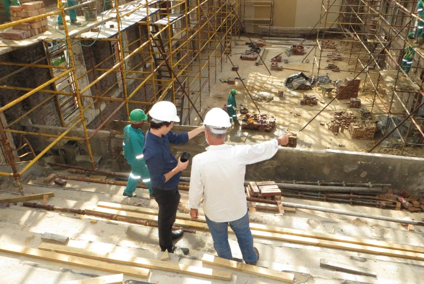 Two men watching a construction site - Planning news and updates