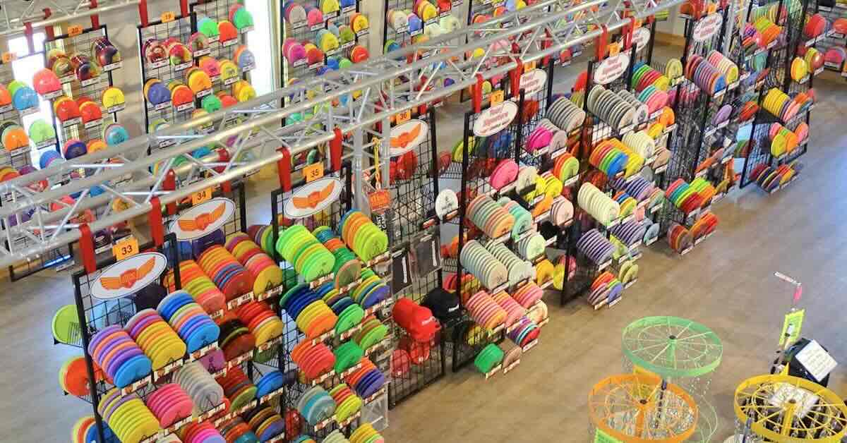 View of a large disc golf disc selection on racks form above