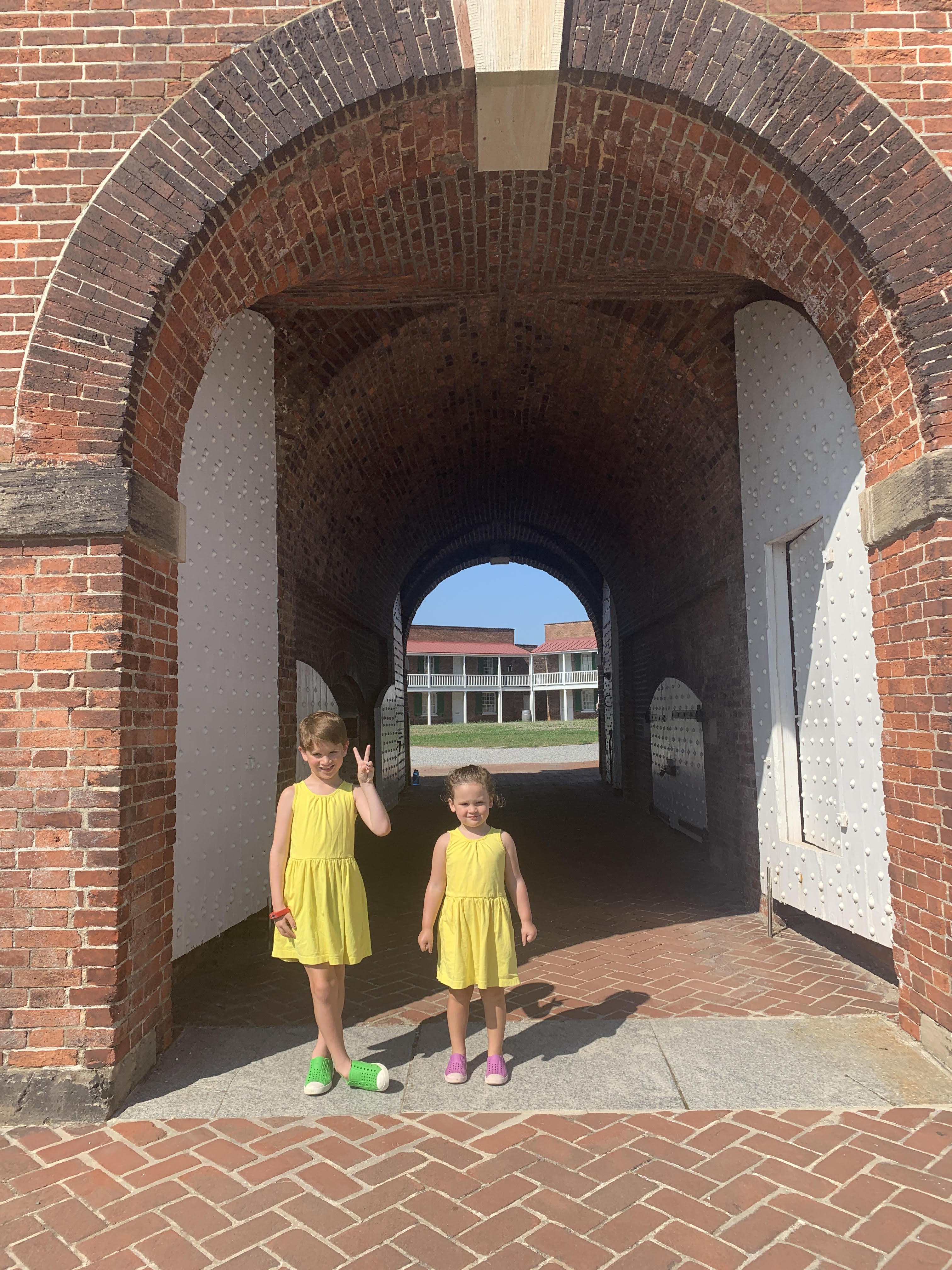 little boy and girl in matching sleeveless sunshine yellow dresses from primary