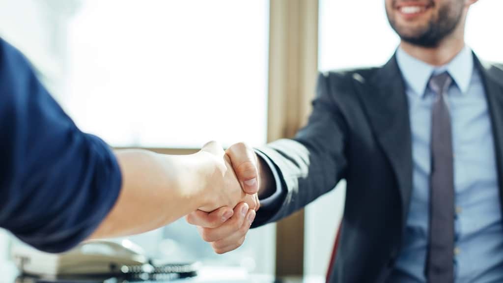 Closing a Deal with a Handshake Image. Opens contact form