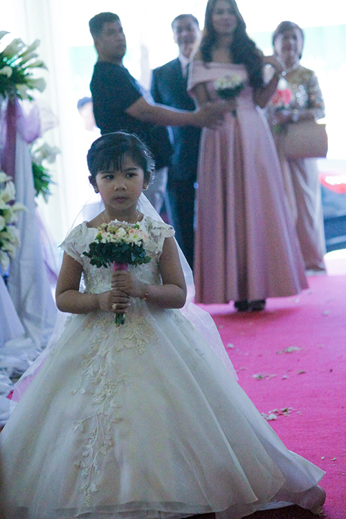 Little bride walking down the aisle