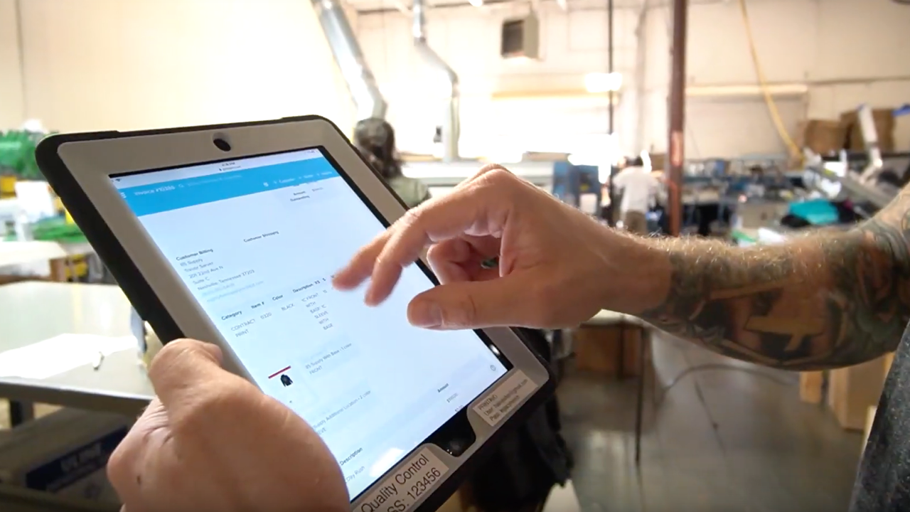 An iPad with Printavo software for screen printing.