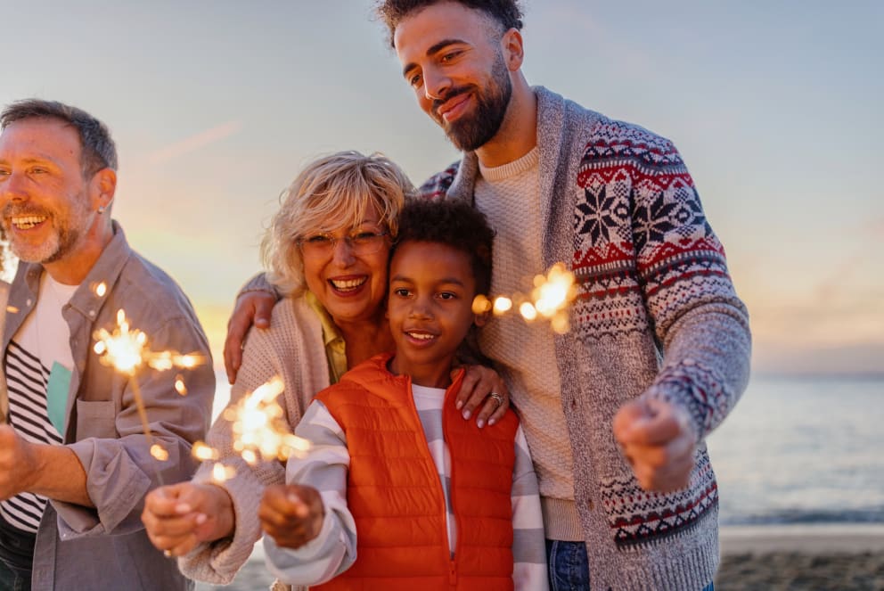 family with sparklers on the beach