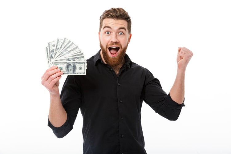 Man holding cash from title loan approval from Mississippi Title Loans, Inc.