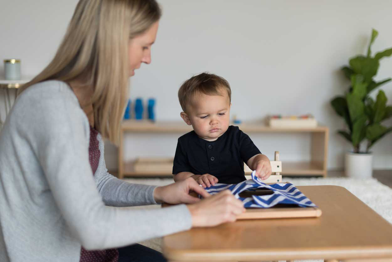 baby and adult touching fabric