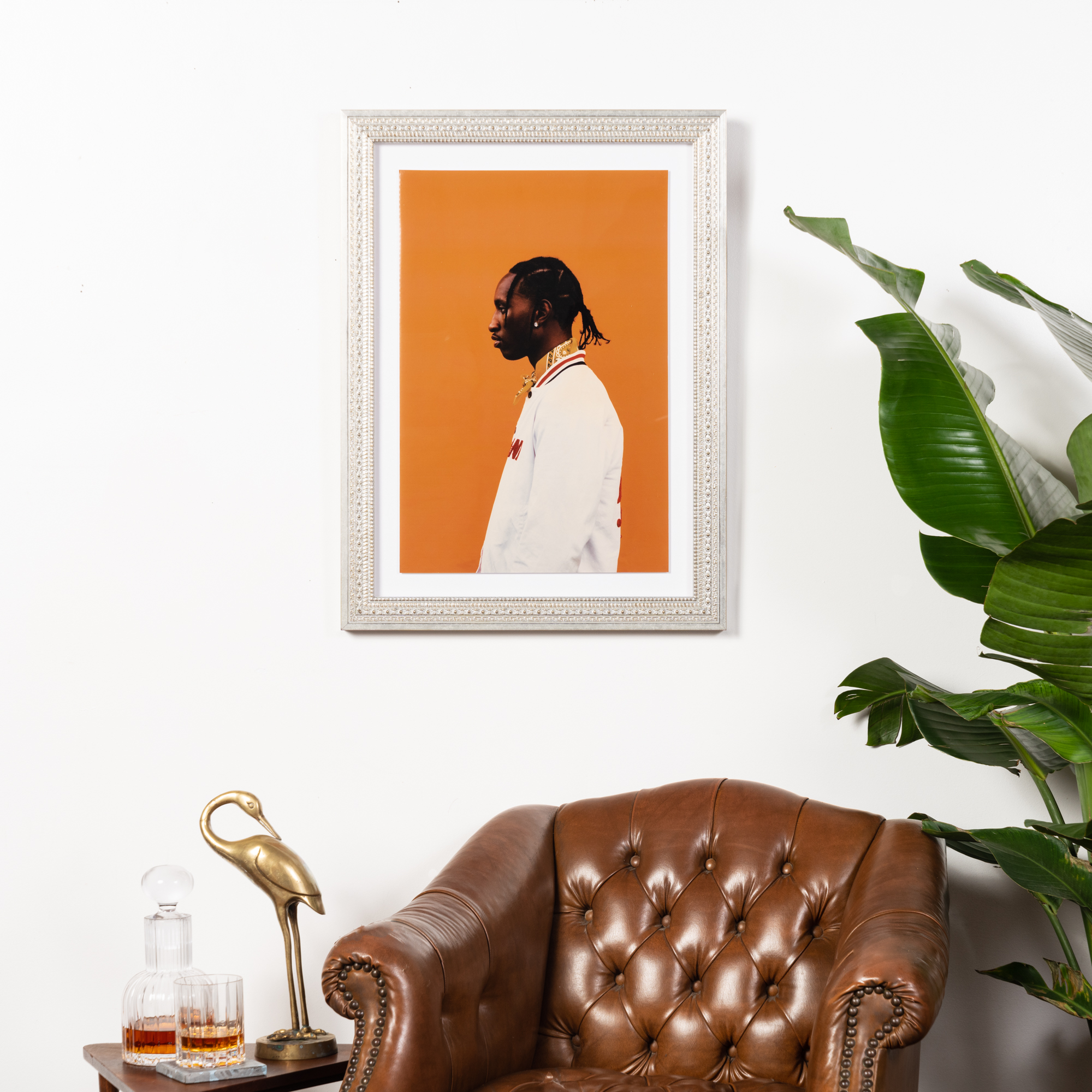 photo of man with orange background in silver frame