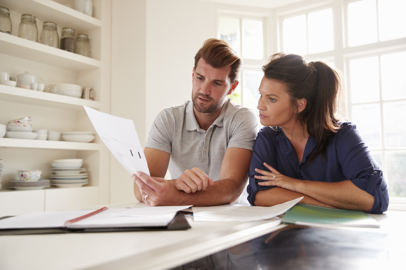 husband and wife looking at their papers