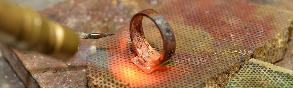 close up view of a ring being soldered