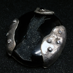 Reticulated silver on a black onyx stone with clear and black CZs