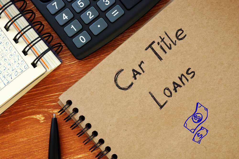 Car title loans written on notebook cover