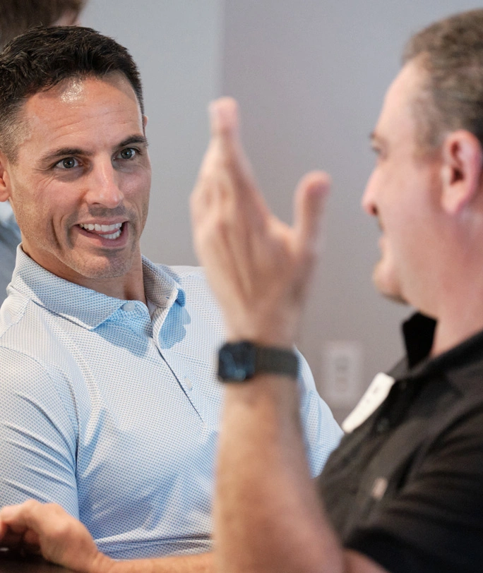 Male Strategic Coach Members discussing about their entrepreneurial business