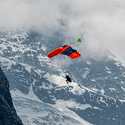 Travelers should budget for extra protection for extreme sports like skydiving.