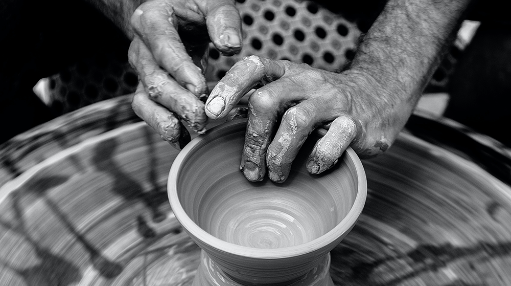 Man making a vase at a potter's wheel
