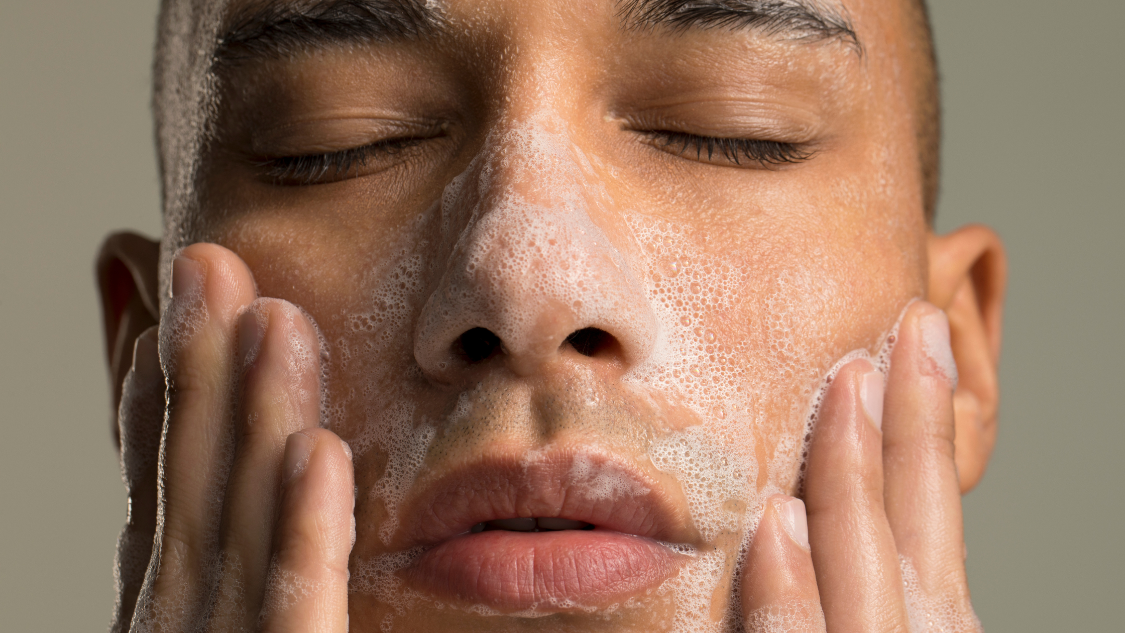 man with dry skin washing his face with a face wash for dry skin