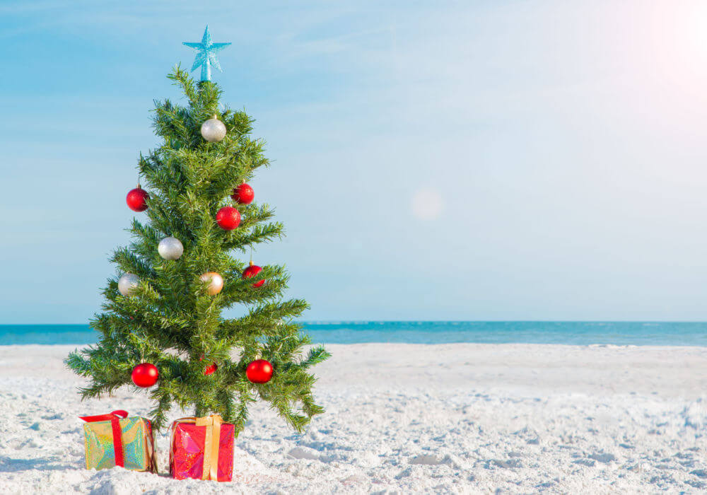 A Christmas tree on a beach reflects things to do in Florida during winter.